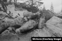 The frozen corpse of a Soviet soldier lies where he died.