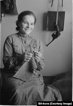 A Finnish woman with a handgun in her homestead. For Finns, the war was a crisis that unified the people and morale among fighters was relatively high.