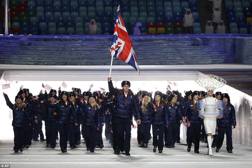 Flying the flag! Jon Eley (centre) of Britain carries the national flag as he leads the team out