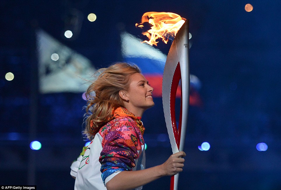 Golden girls: Russian tennis player and Olympic medalist Maria Sharapova runs with the Olympic torch